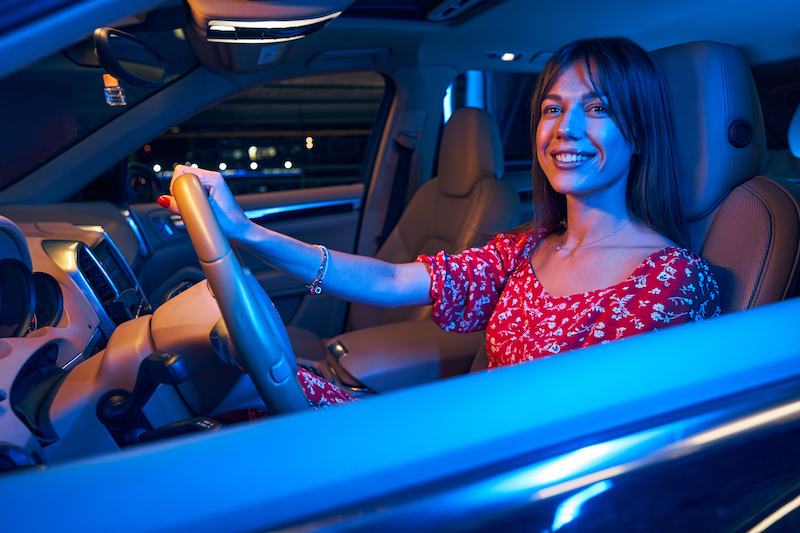 Happy New automobile Owner pulls out of the car lot